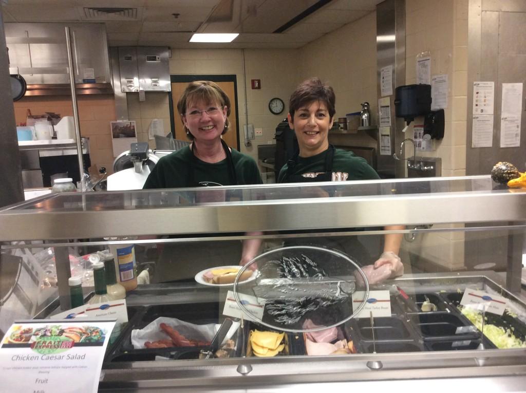 Katy Dâ€™Aesio and Cathy McLaughlin make customized paninis, wraps, and sandwiches during the busy lunch rush