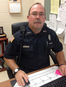 Officer Phillip Powers, the Hopkinton School District's on-duty school resource officer, patrols schools in the district in order to avert potential violent intruders. Photo by Kora Sileog