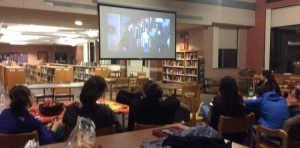 Seniors, Hannah Sherffius, Rachel DerKinderen, Leticia Namanda, Kyra Moed, Christina Goncalves and Max Goldberg, watching Hocus Pocus displayed on the movie night. Photo by Sabrina Martin 