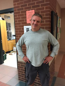 Wellness teacher Michael Hooker standing outside the wellness offices in-between class periods. Photo by Veronica Lee. 