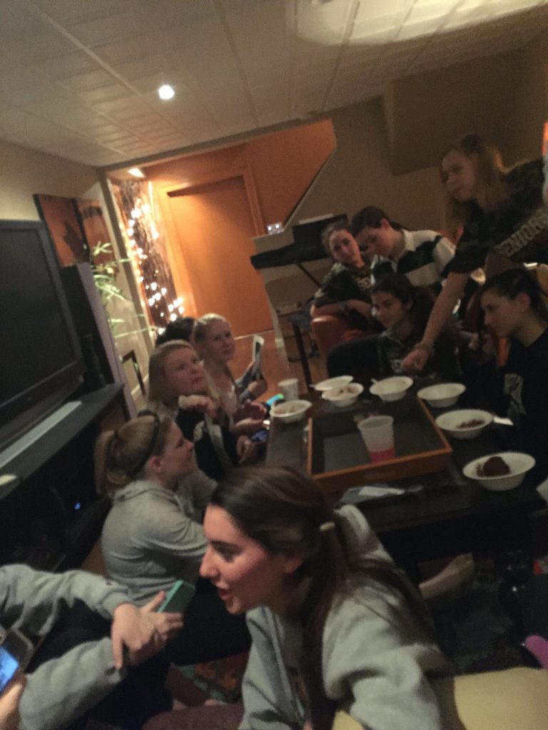 The senior girls get together the night before the game to eat, do their hair, and have fun. Photo by Emma Zack.