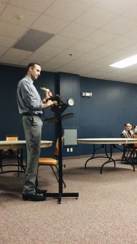 Principal Evan Bishop unveils the powderpuff trophy, and inspires the players with a speech. Photo by Emma Zack.