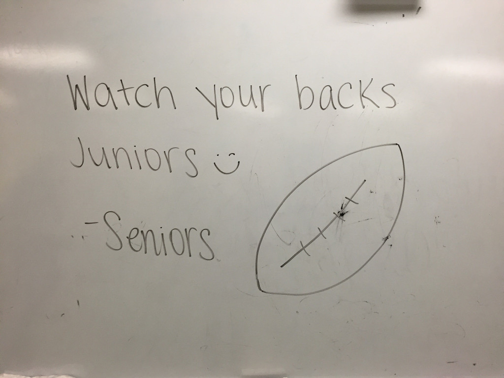 The seniors leave a message for the juniors on the whiteboard in the girls team room. Photo by Casey Palmer.