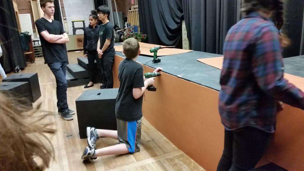 Crew member Tommy Fromer in the process of building one of the show’s set pieces.