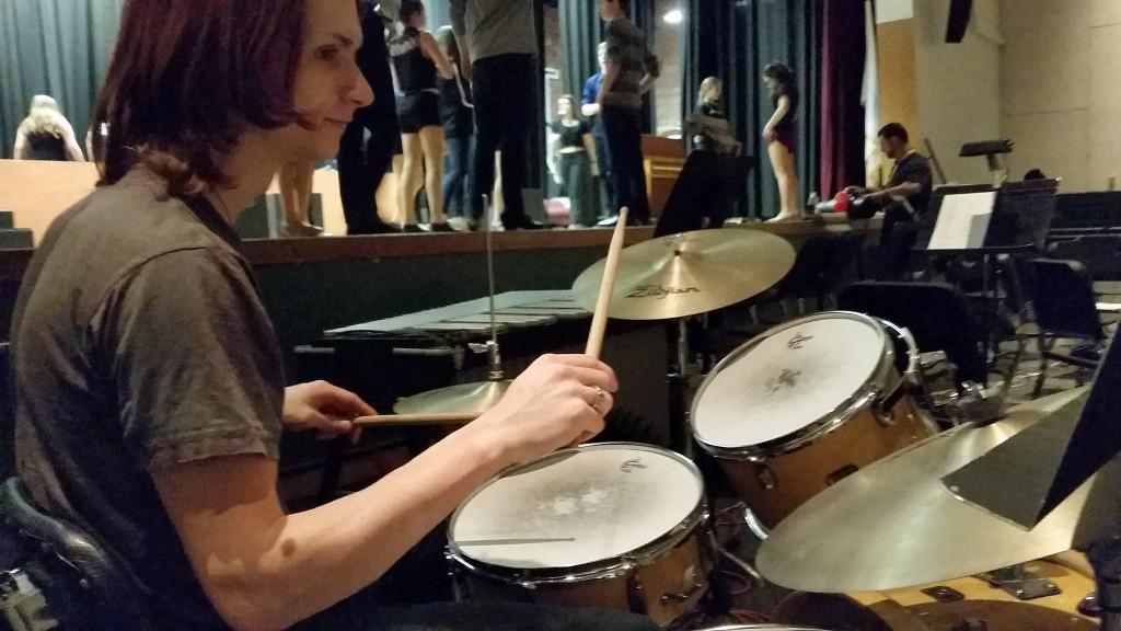 Samuel Faucher practicing the drums prior to the start of a run through. 
