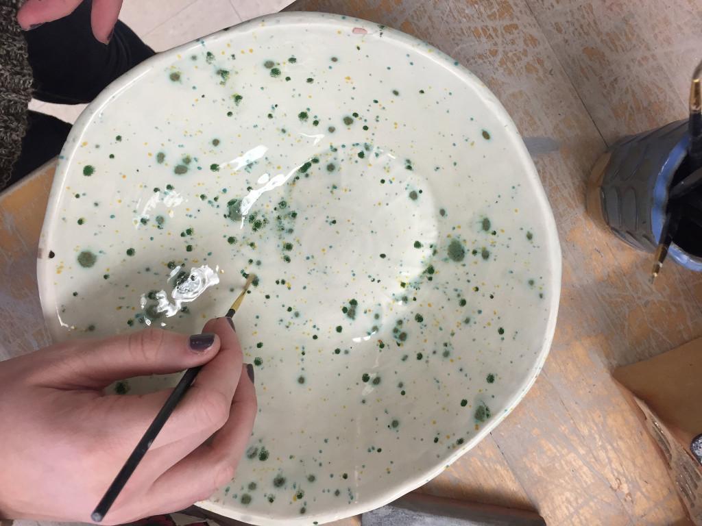 Student Marisa Nagel glazes her bowl. Photo by Casey Palmer.