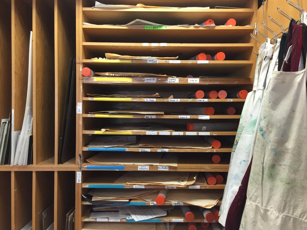 Students store their artwork on shelves along the walls of the art room. Photo by Emma Zack. 