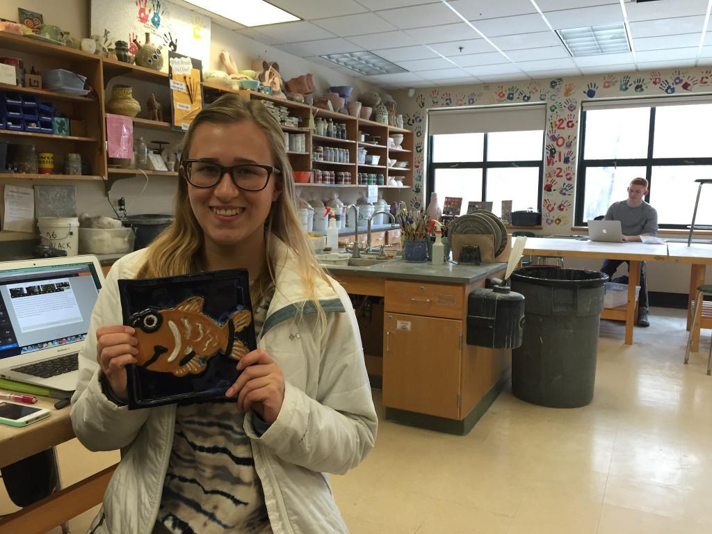 Senior Jill Kellet shows off her latest project. Photo by Casey Palmer.