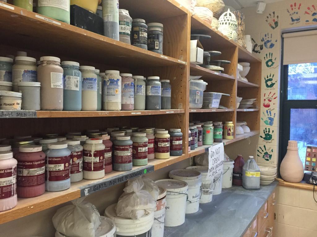 Different glazes line the shelf of the Ceramics room. Photo by Casey Palmer.