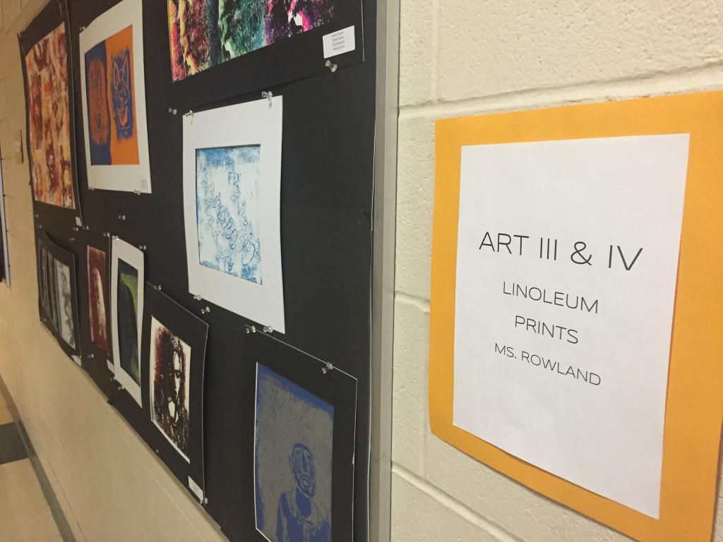 Art made by Hopkinton High School Students hangs on the display board outside of the art room. Photo by Allison McNulty.