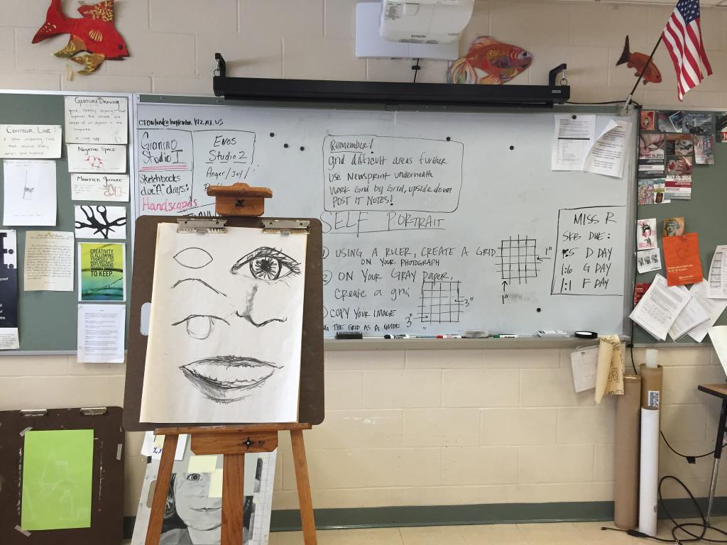 Instructions for the class are displayed on the whiteboard, and examples for the class to follow are pictured on an easel. Photo by Allison McNulty.