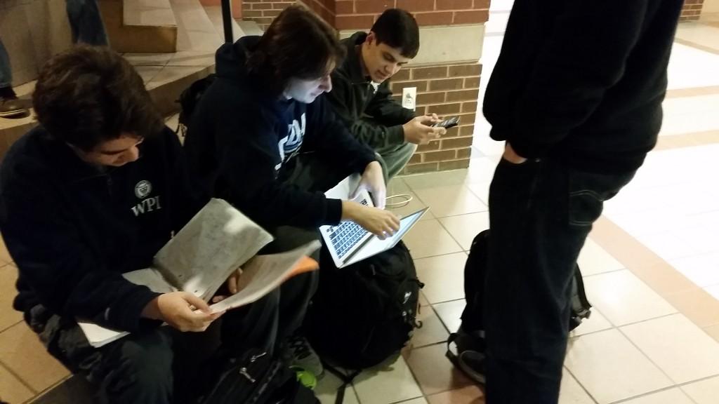 Seniors Jeremy Jacobs, Michael Palmieri and Blake Dobay combine studying methods in preparation for their calculus final. Jeremy uses his notes, Michael uses his laptop, and Blake uses his calculator to solve math problems. 