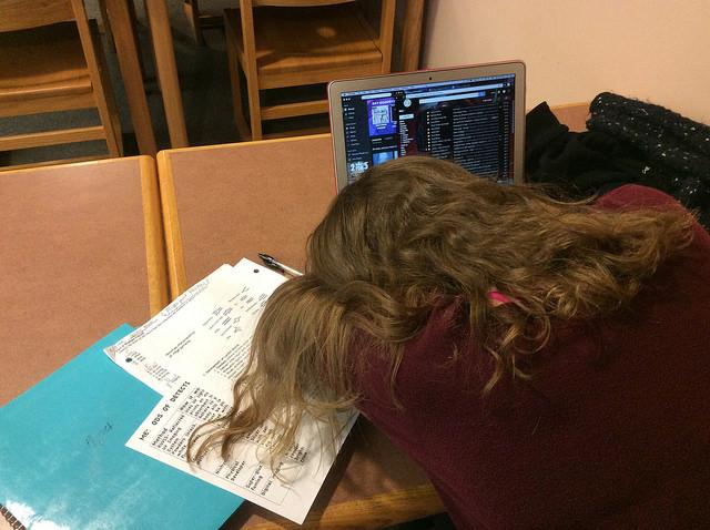 A senior asleep in front of her homework during first period study in the library. Photo by Sarah Fromer.