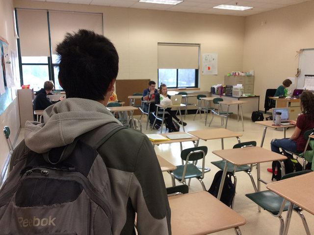 Brian Gao, a senior, entering first period Spanish class late. Photo by Josh Normandeau.